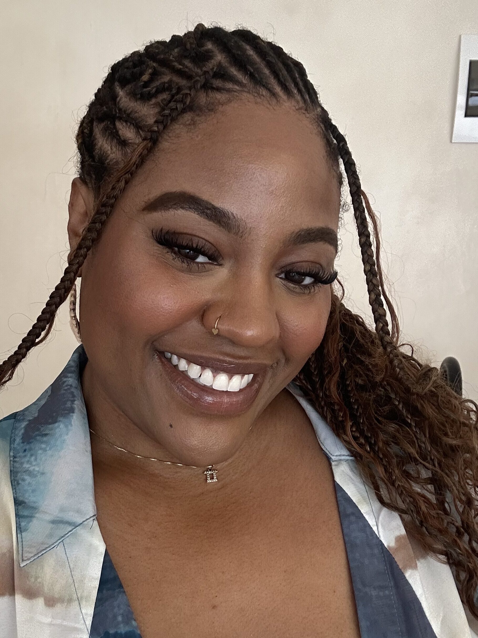 IMG_9729 Grace Asiegbu is smiling at the camera. She's wearing an ocean-printed button-down shirt and a gold Gemini necklace.